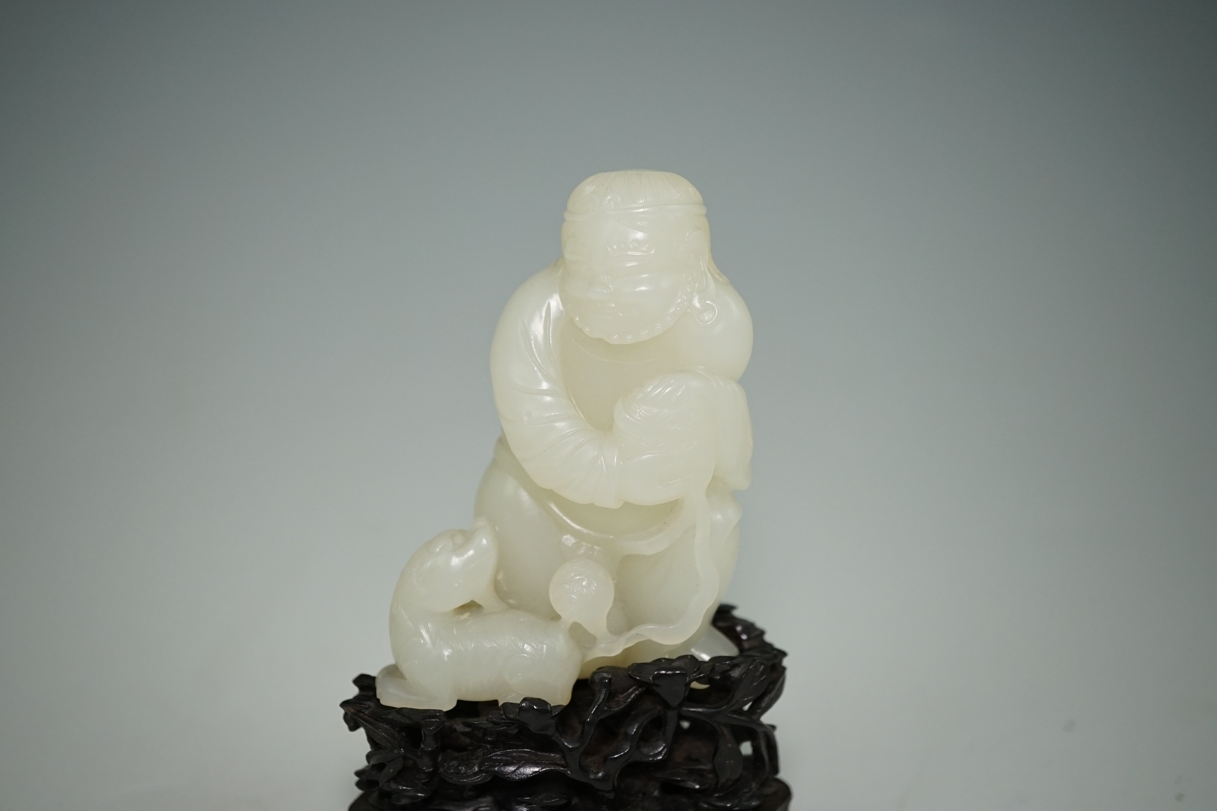 A fine Chinese white jade group of a bearded foreigner, 18th century